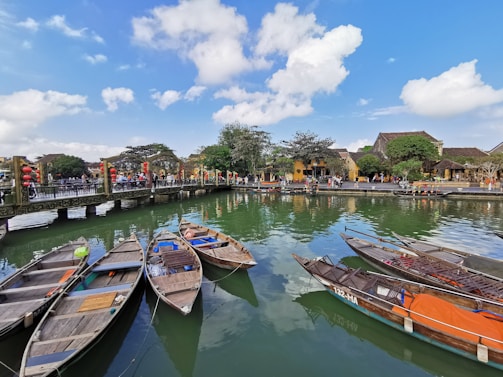 Colorful traditional boats floating on the serene waters of Fenghuang old town.