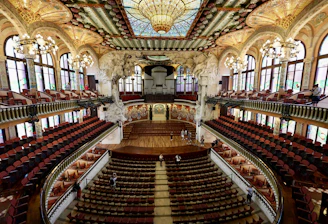 An old concert hall with wooden seats and ornate decorations.