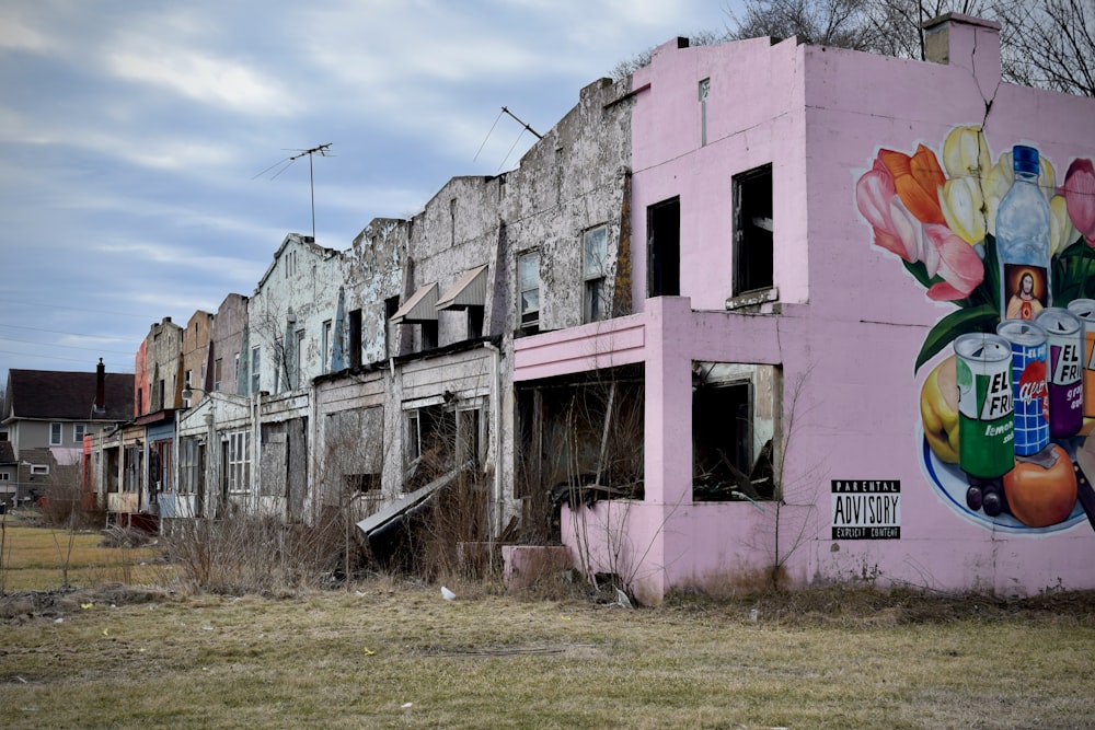 a pink building with a mural on the side of it