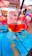 A vibrant photo of colorful custom koozies displayed on a sunny beach bar counter.