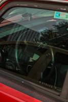 A car parked safely with a visible insurance document on the dashboard.