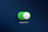 a green button with the word creativity on it