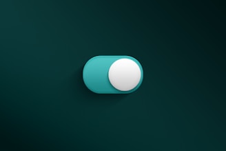 a blue and white button on a green wall