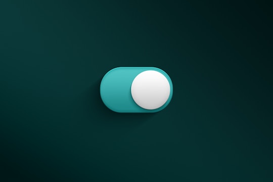 a blue and white button on a green wall