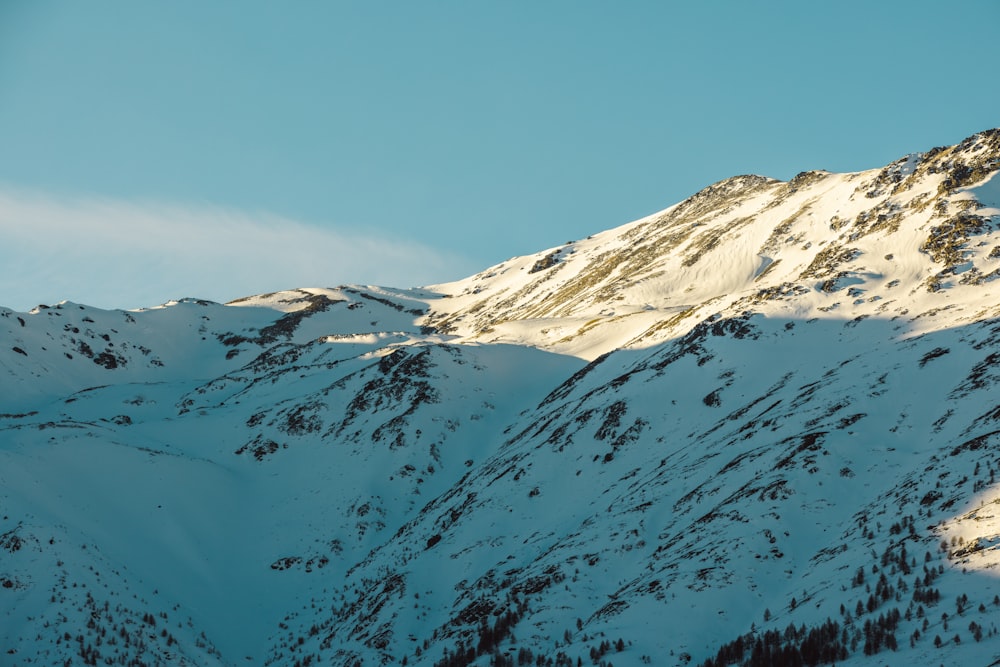 a mountain covered in snow under a blue sky