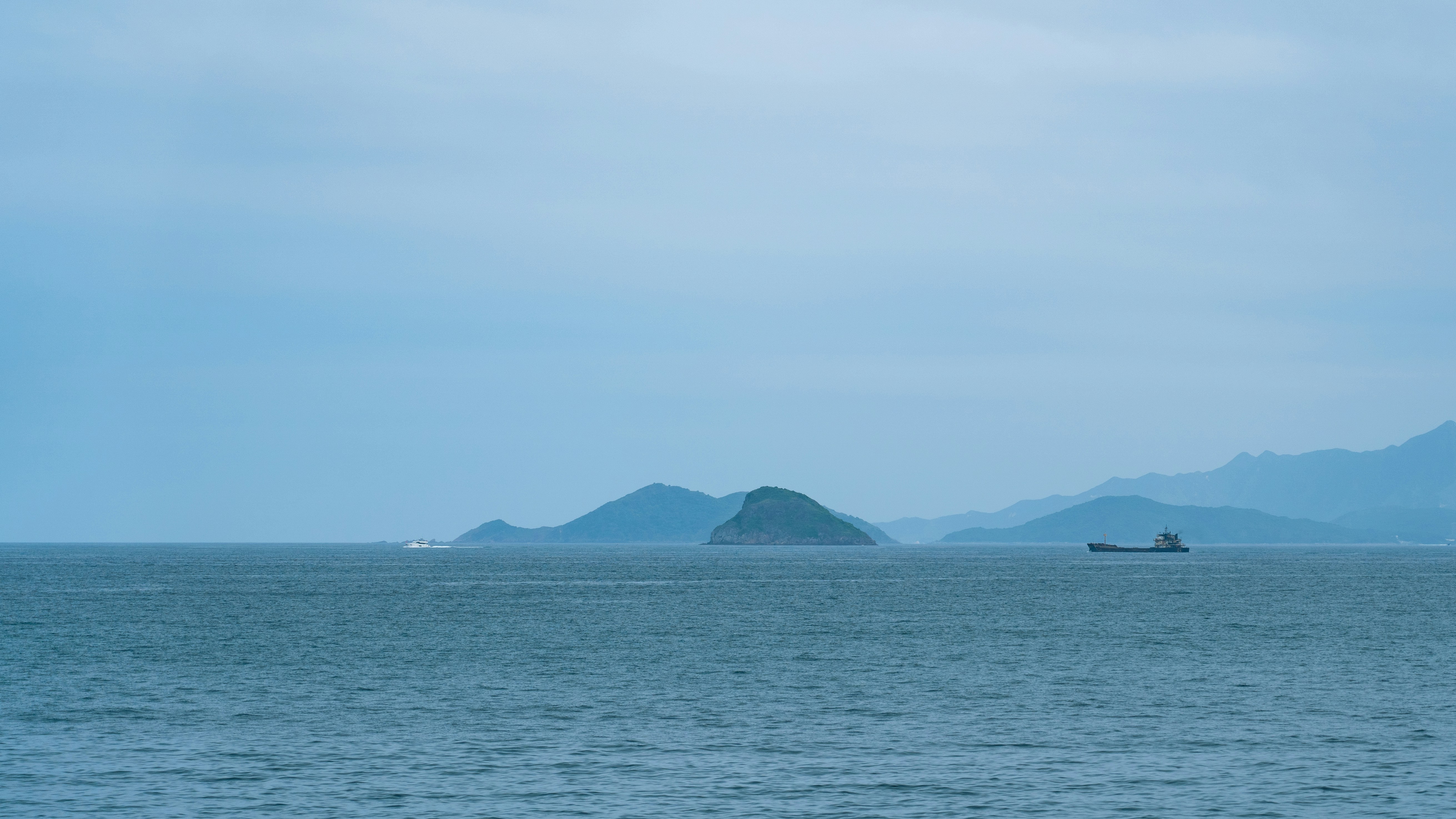 a large body of water with mountains in the background