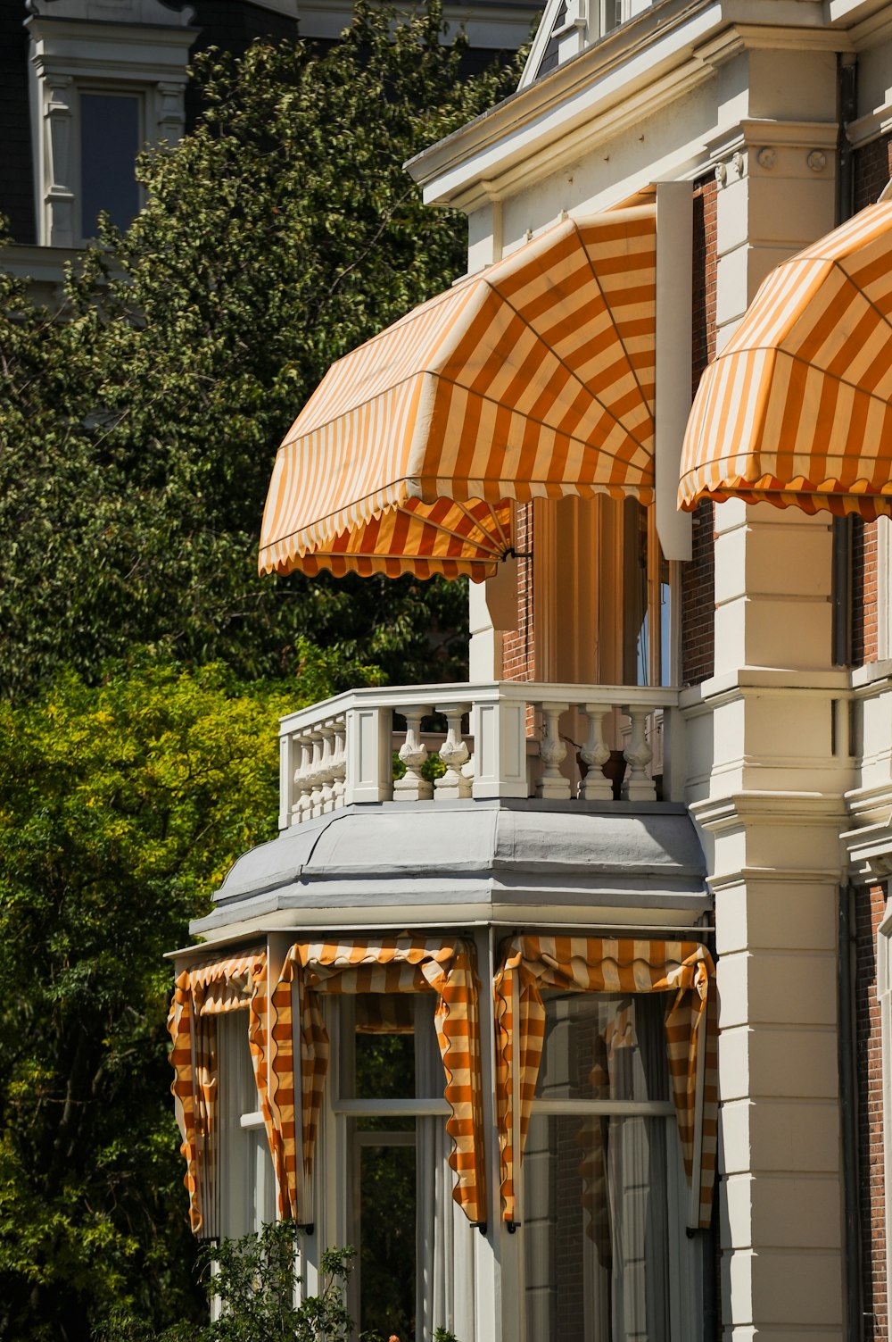 an orange and white striped awning on a building