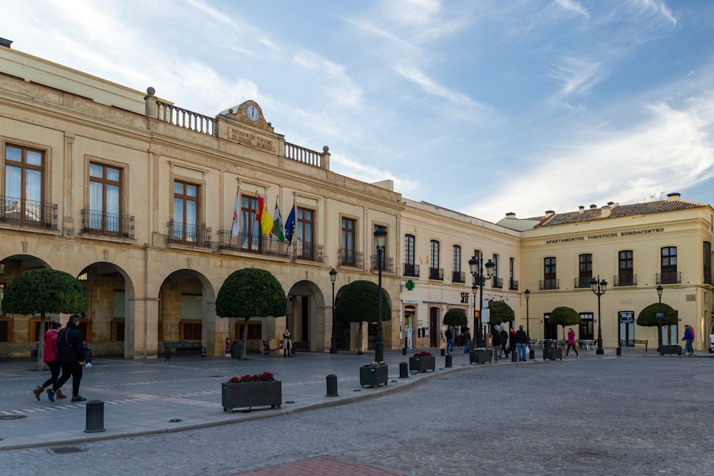 a group of people walking in front of a building