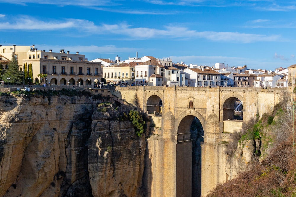 a bridge over a canyon with buildings on top of it