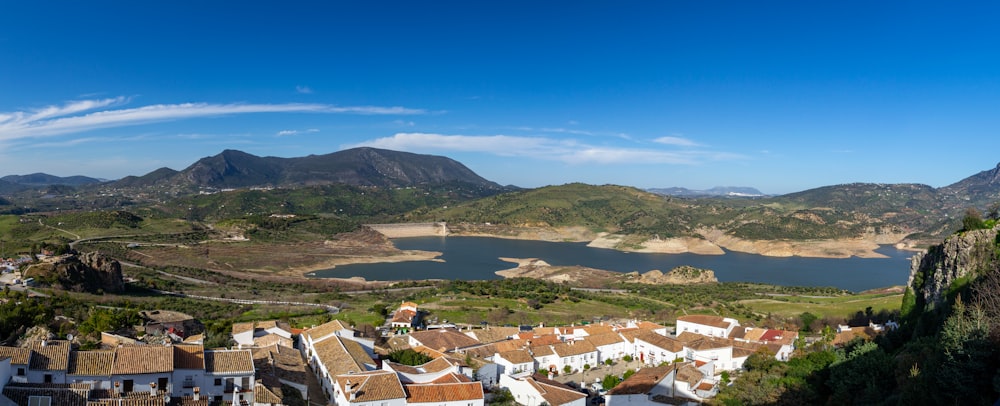 a scenic view of a town with mountains in the background