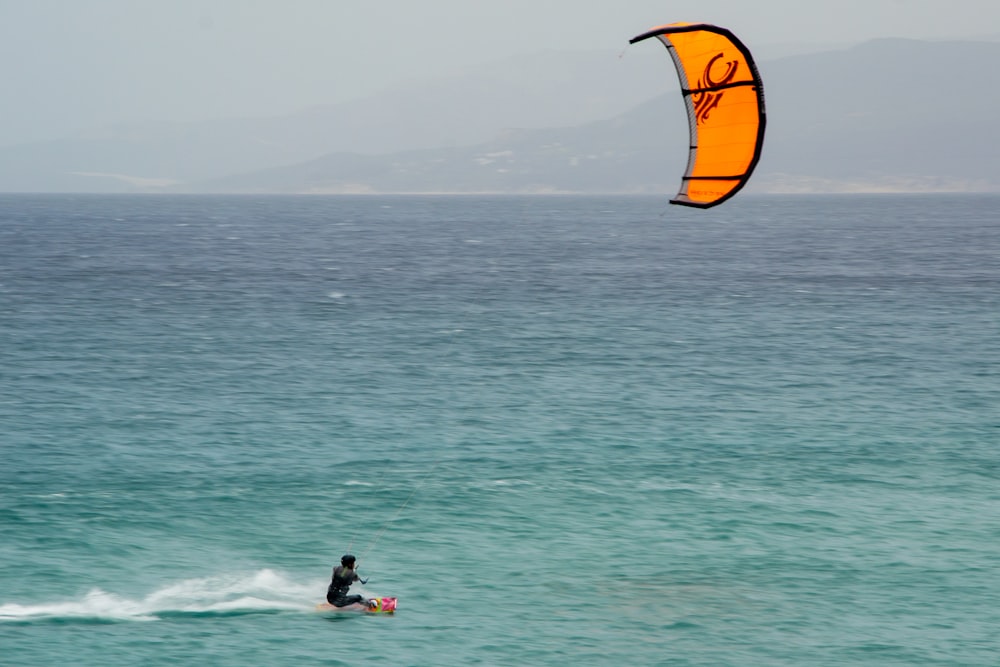 a person riding a surf board on a body of water