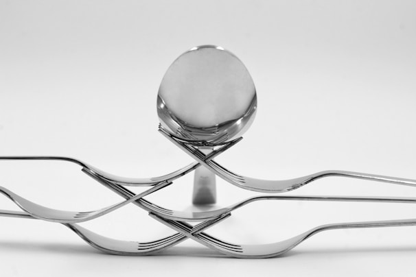 Elegant arrangement of luxury cutlery set with polished blades reflecting soft light