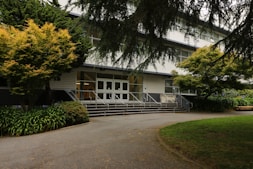A welcoming entrance to a residential care facility with greenery.