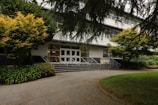 A secure entrance to a senior housing building with clear signage and well-maintained landscaping.