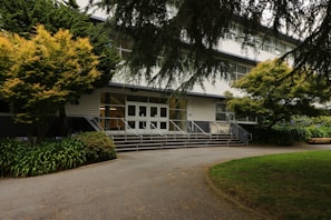A welcoming entrance of a residential building with greenery.
