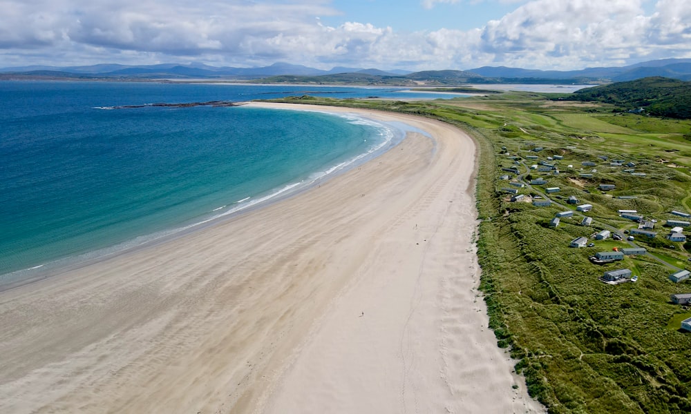 an aerial view of a sandy beach and ocean