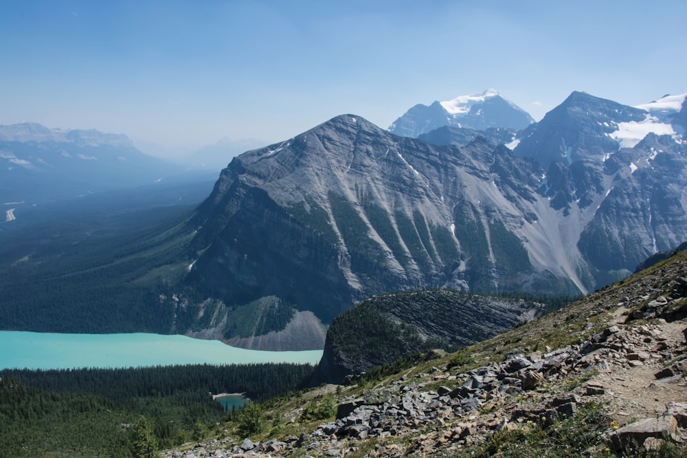 a view of a mountain range with a lake in the foreground
