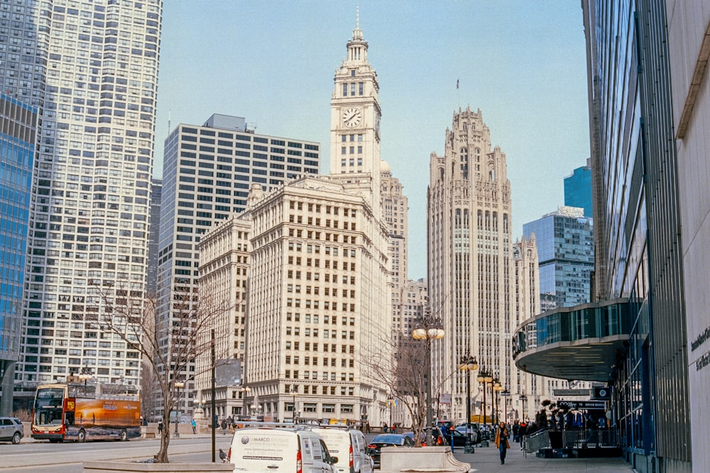 a city street with tall buildings in the background