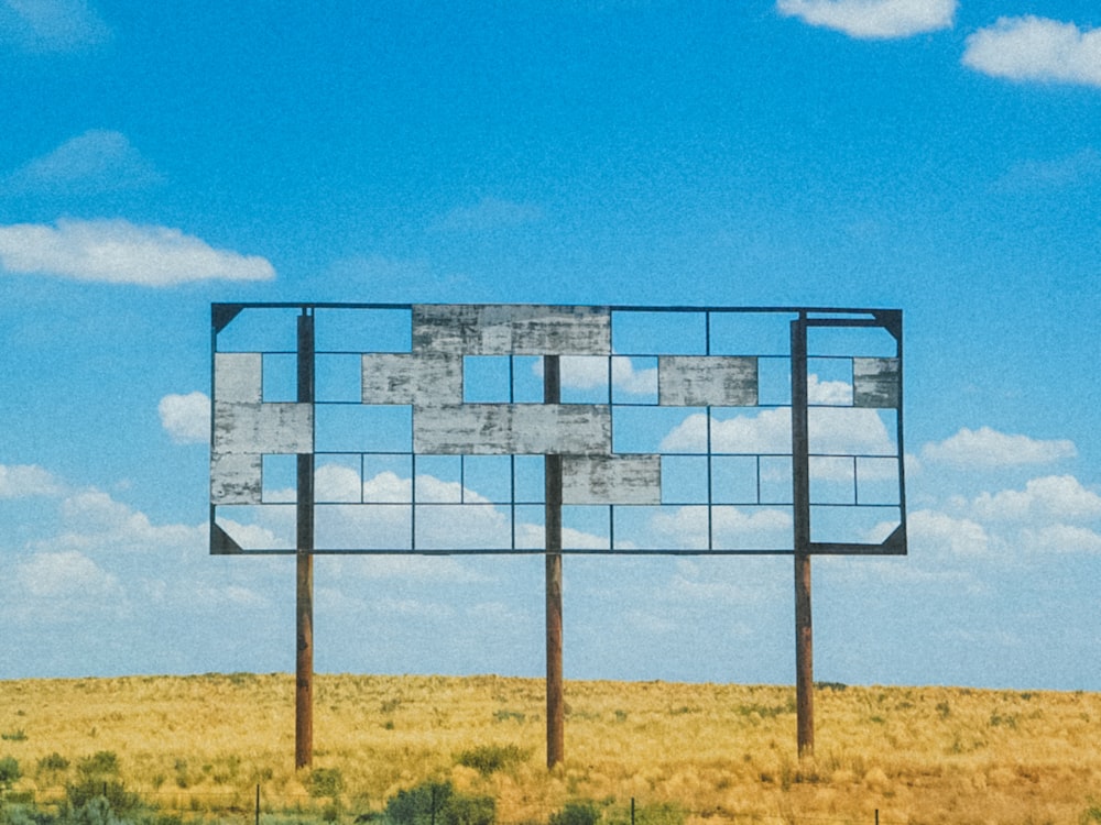a large billboard sitting in the middle of a field