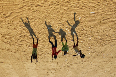 Illustration of the four siblings playing together under a warm desert sunset.