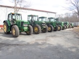 A fleet of agricultural equipment lined up neatly outside the manufacturing plant.