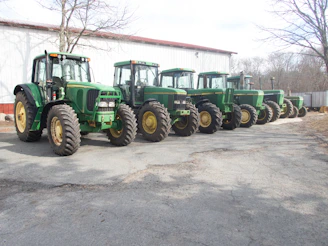 Rows of modern farming equipment displayed in a bright showroom