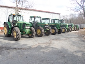 A variety of agricultural equipment lined up for sale.
