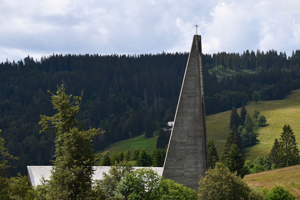 a very tall steeple with a cross on top of it