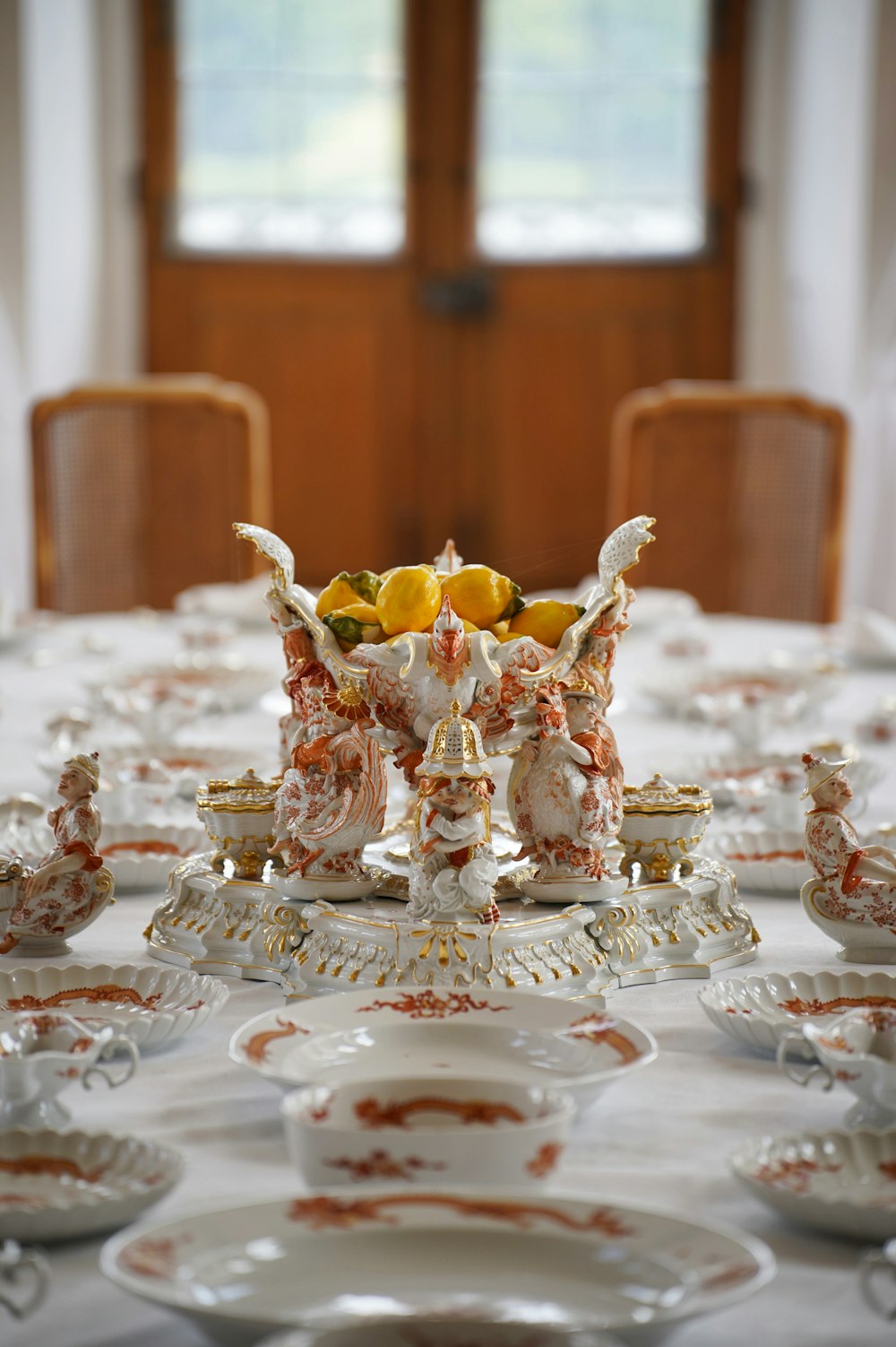 a white table topped with lots of plates and cups