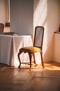 a chair sitting in front of a table with a white tablecloth