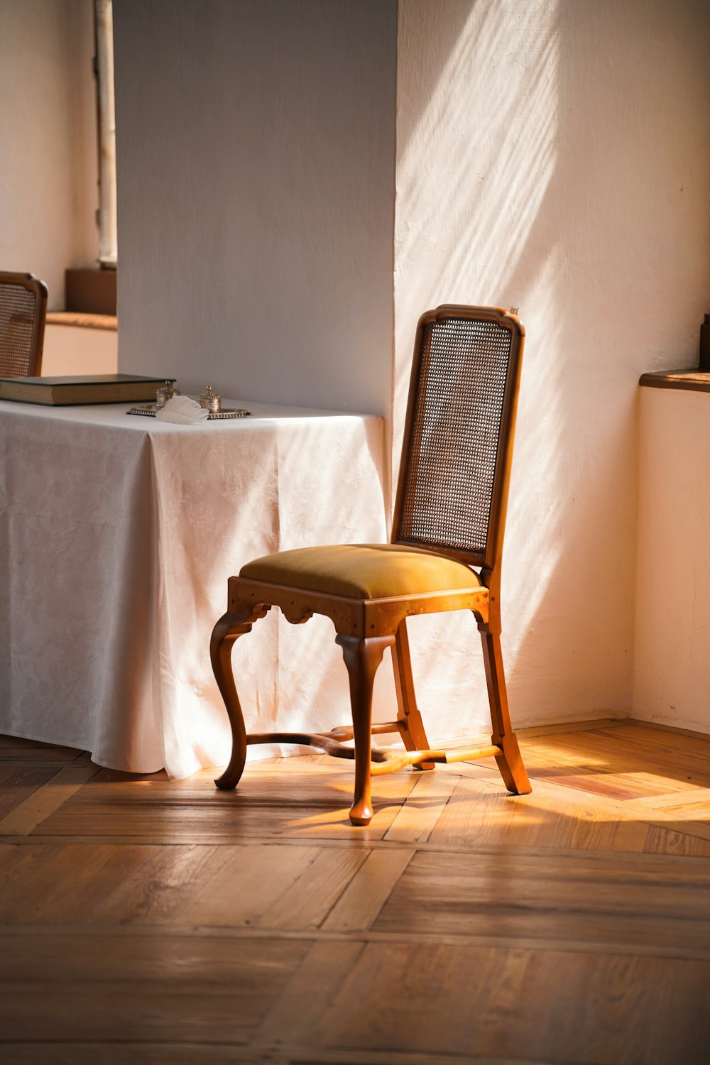 a chair sitting in front of a table with a white tablecloth