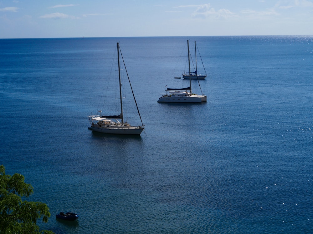 a couple of boats floating on top of a large body of water