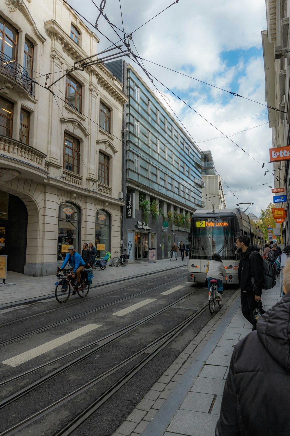 a city street filled with people and a bus