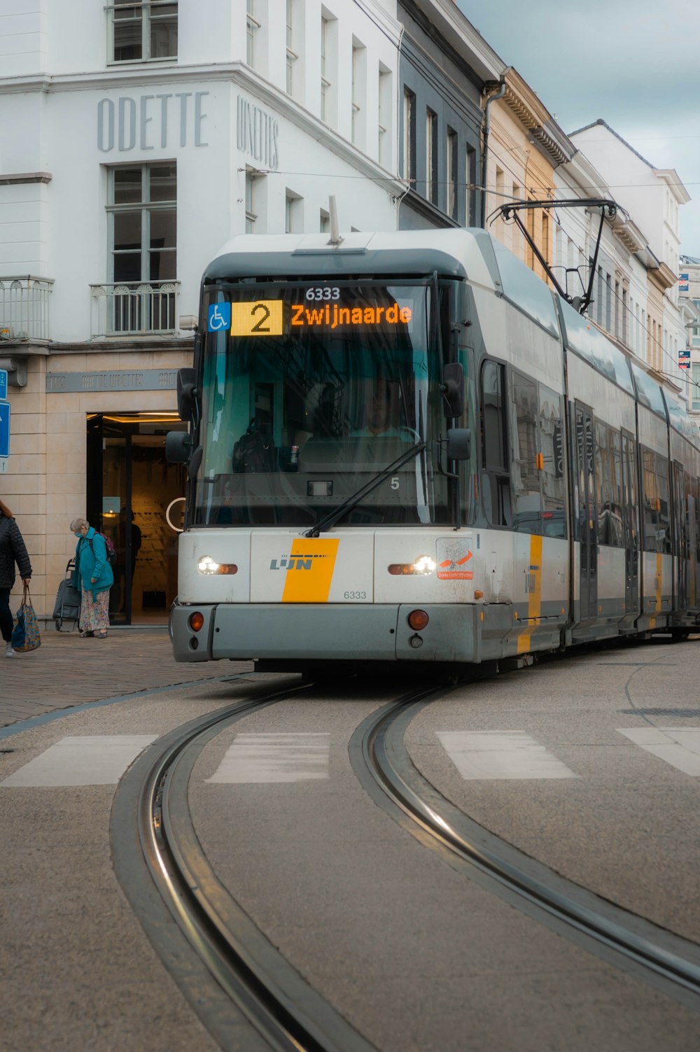 a train on a track in front of a building