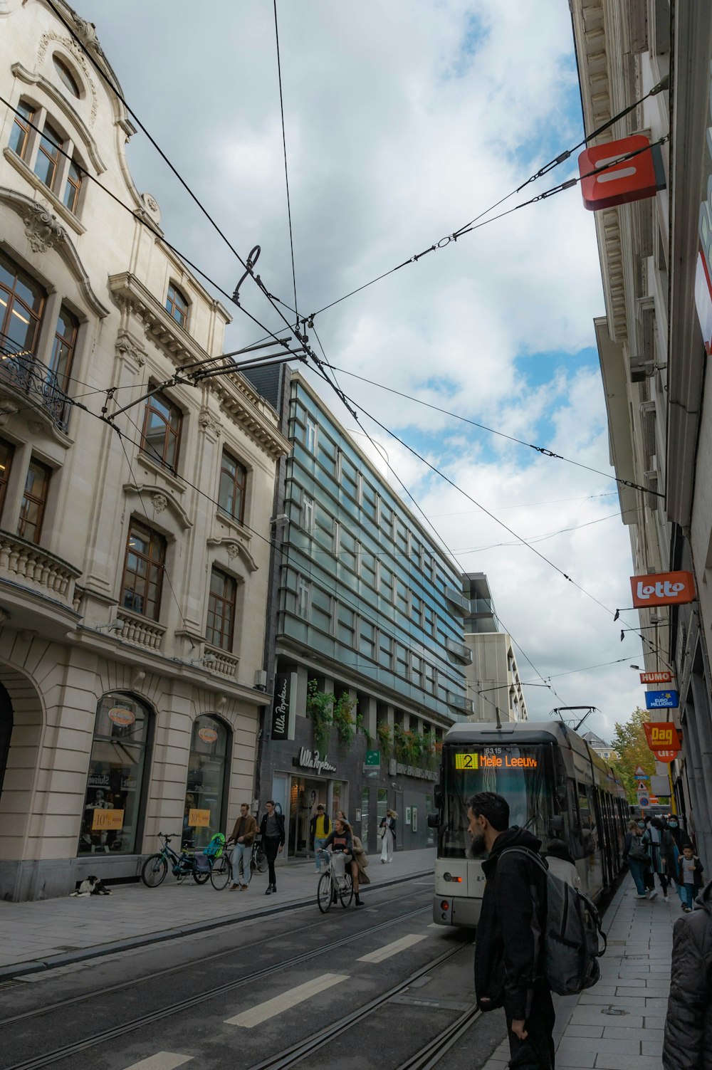 a city street filled with people and a bus