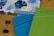 Two 2020 planners or notebooks are prominently displayed, one in blue and the other in green, each with a decorative striped pattern. A floral design is visible in the background on another item. A black binder clip is also seen on the wooden surface.