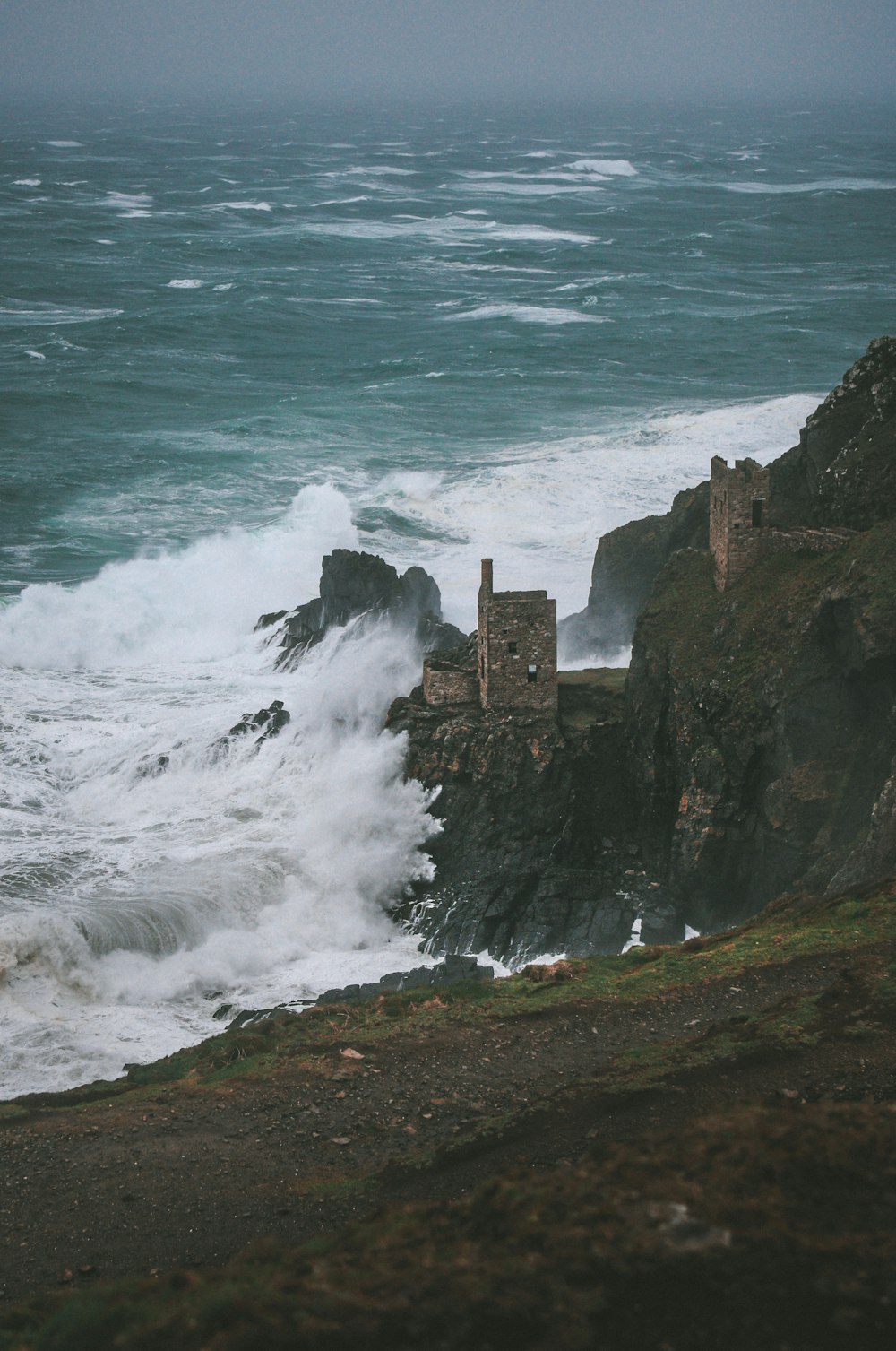 a large body of water next to a rocky cliff