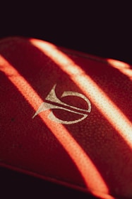 Close-up of hands applying branding materials with dark red and yellow accents.