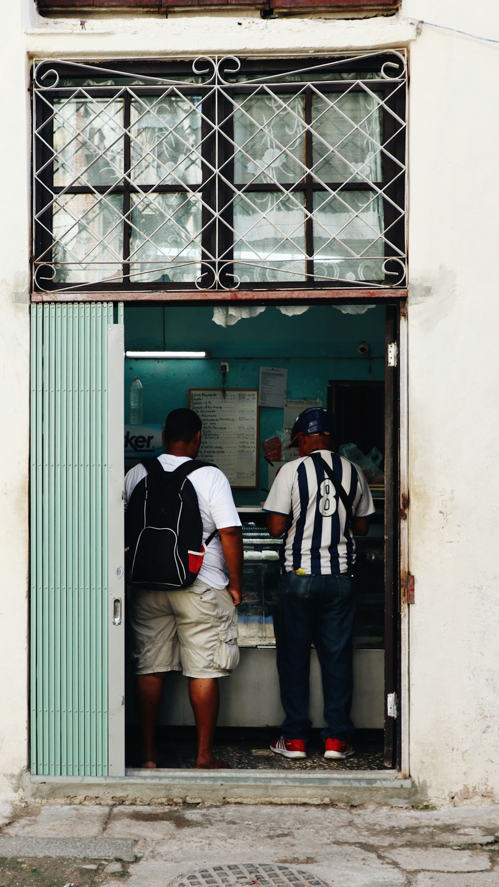 a couple of men standing in a doorway of a building