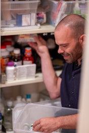a man standing in front of an open refrigerator