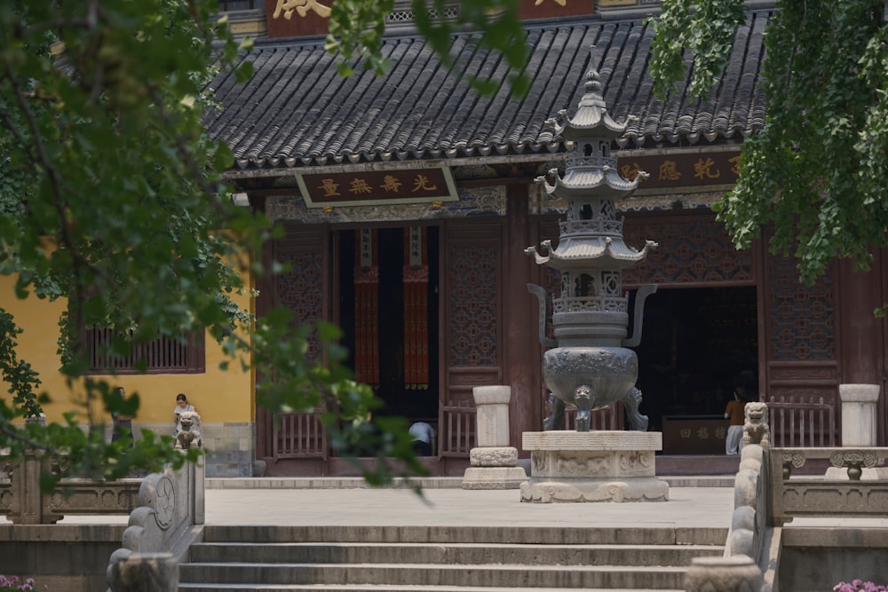 a stone fountain in front of a building