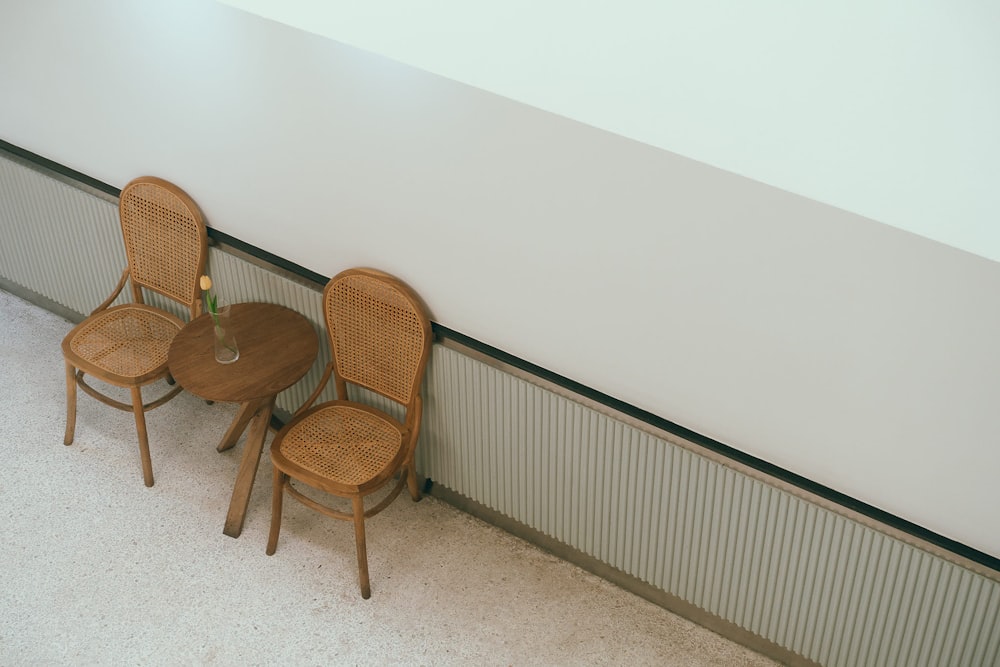 a couple of chairs sitting next to a wall
