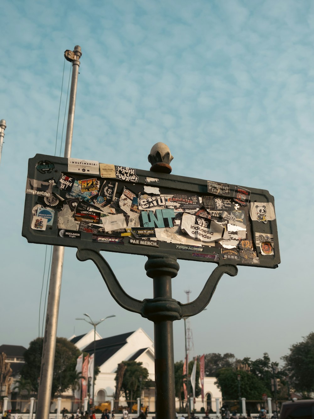 a street sign with a lot of stickers on it