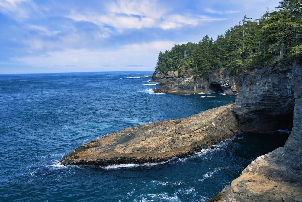 a large body of water near a rocky cliff