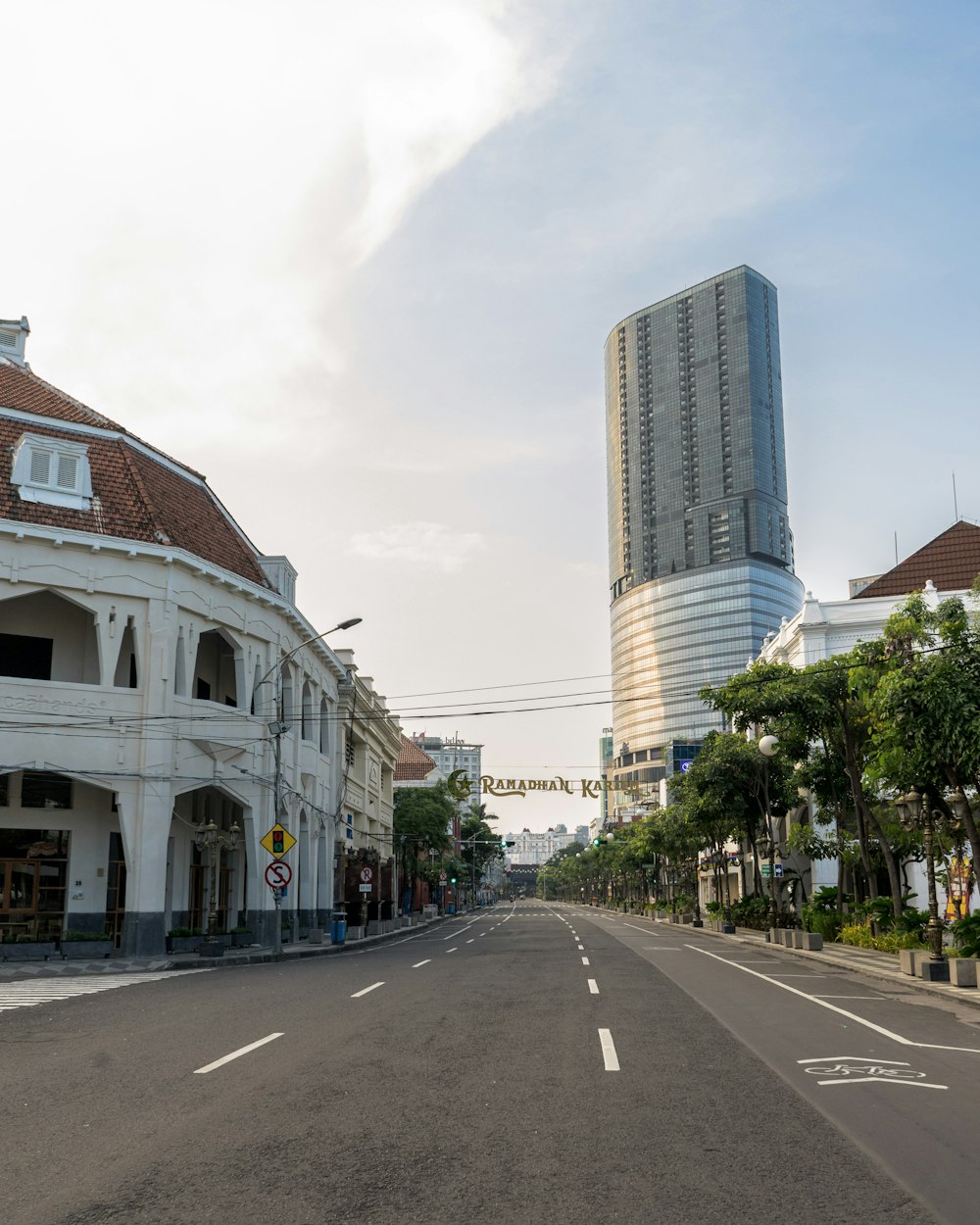 an empty street with buildings in the background