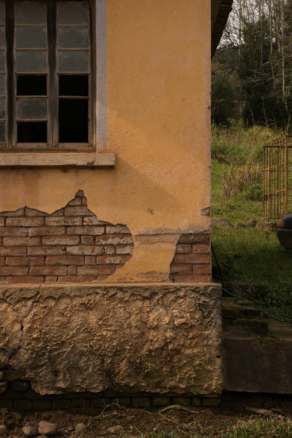 a brick building with a broken window on the side of it