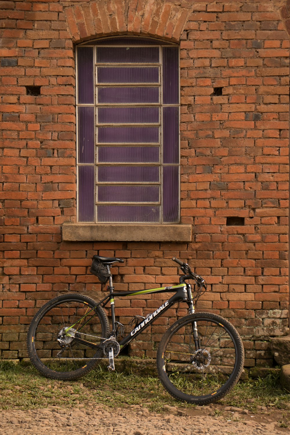 a bike parked in front of a brick building