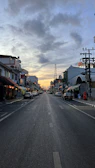 Wide shot of an empty urban street at dusk, emphasizing contrast and quiet atmosphere.