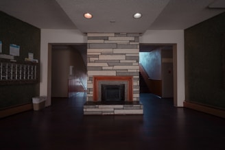 a living room with a fireplace and a fire place