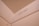 An interior corner of a room features a beige wall with a visible weight capacity indication marked 'MAX CAP - 1200 LBS -'. The surface appears smooth and painted, with lighting giving it a warm hue.